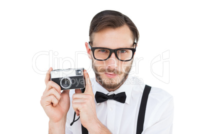 Geeky hipster holding a retro camera