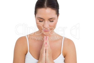 Peaceful brunette meditating with her eyes closed