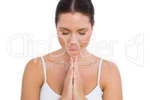 Peaceful brunette meditating with her eyes closed