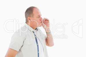 Older man holding hand to mouth for silence
