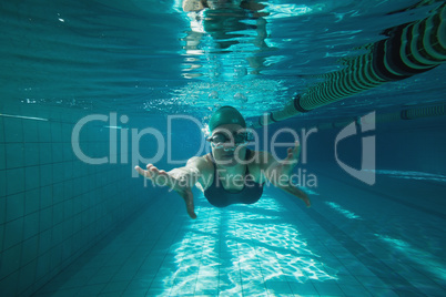 Athletic swimmer swimming towards camera