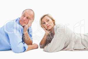 Mature couple lying and thinking