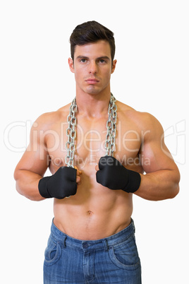 Portrait of a serious shirtless young muscular man