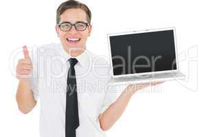Geeky businessman holding his laptop showing thumbs up