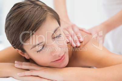Attractive woman receiving back massage at spa center Attractive woman receiving back massage at spa center