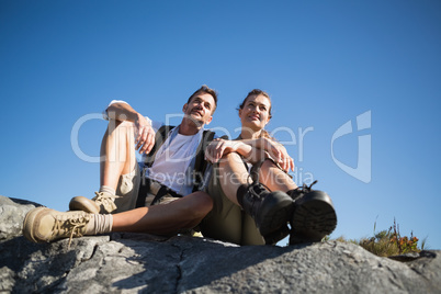 Hiking couple looking out over mountain terrain