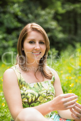 Cute young woman relaxing in field