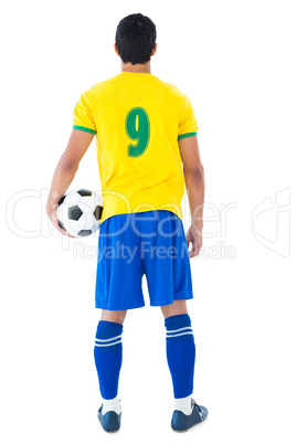 Football player in yellow holding ball