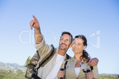 Hiking couple pointing and looking in the countryside