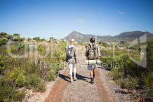 Hiking couple walking on mountain terrain