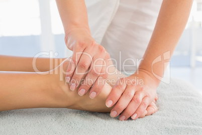 Woman receiving leg massage at spa center