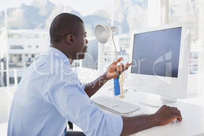 Focused businessman working at his desk on video chat