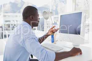 Focused businessman working at his desk on video chat