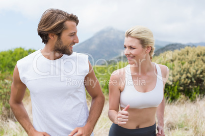 Attractive couple jogging on mountain trail