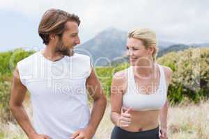 Attractive couple jogging on mountain trail