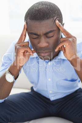 Stressed businessman getting a headache