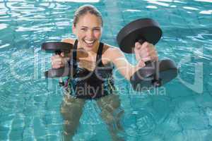 Fit blonde working out with foam dumbbells