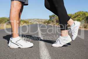 Fit couple standing on the open road together