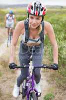 Fit couple cycling on mountain trail