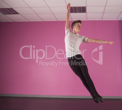 Focused male ballet dancer leaping up