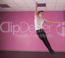 Focused male ballet dancer leaping up