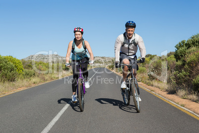 Active couple going for a bike ride in the countryside