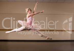 Beautiful ballerina dancing in pink tutu