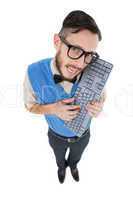 Geeky hipster looking at camera holding keyboard