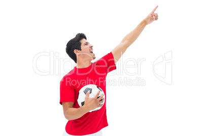 Football player in red holding ball and pointing