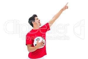 Football player in red holding ball and pointing