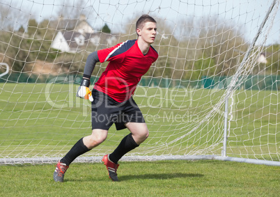 Goalkeeper in red ready to make a save