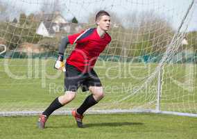 Goalkeeper in red ready to make a save