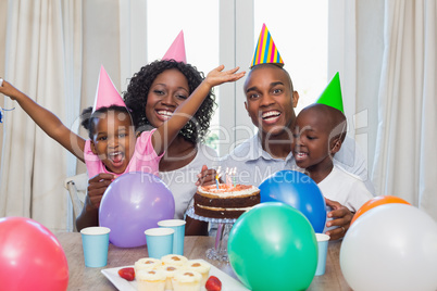 Happy family celebrating a birthday together at table