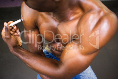 Shirtless muscular man injecting steroids