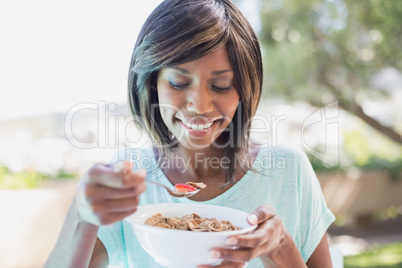 Pretty woman having her breakfast outside