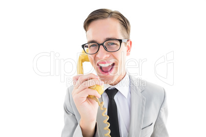 Geeky businessman talking on retro phone