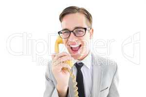 Geeky businessman talking on retro phone