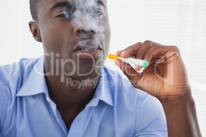 Businessman smoking an electronic cigarette