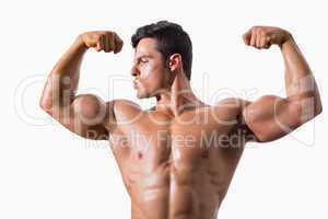 Portrait of a muscular young man flexing muscles