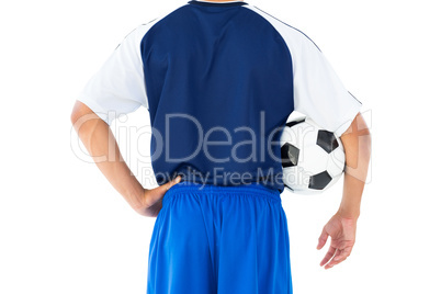 Football player in blue holding ball