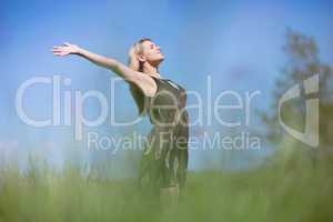 Pretty blonde in sundress standing with arms out