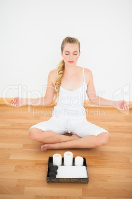 Peaceful blonde sitting in lotus pose