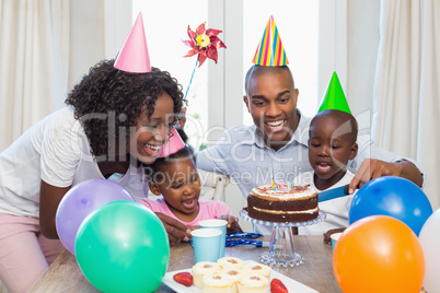 Happy family celebrating a birthday together at table