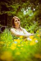 Cute young woman relaxing in field