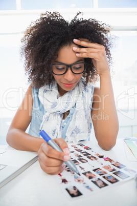Pretty photo editor working at her desk Pretty photo editor working at her desk