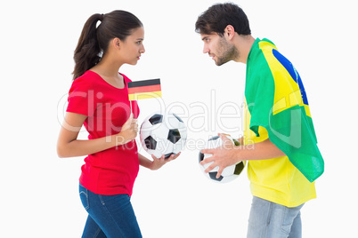 German and brazilian football fan facing off
