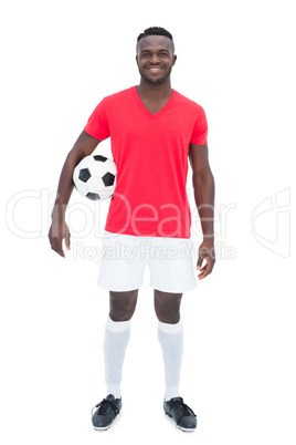 Football player in red jersey holding ball