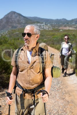 Happy hiking couple walking on mountain trail