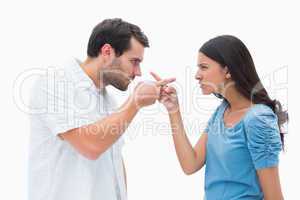 Angry couple pointing at each other