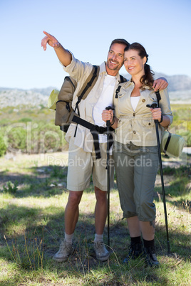 Hiking couple pointing and looking in the countryside